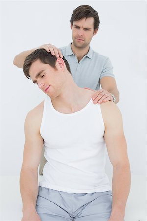 simsearch:400-07232187,k - Male chiropractor doing neck adjustment in the medical office Foto de stock - Royalty-Free Super Valor e Assinatura, Número: 400-07232071