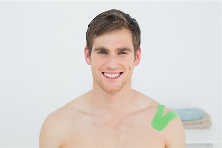 physical therapy shoulder - Portrait of a handsome young man with green kinesio tape on shoulder in the medical office Stock Photo - Budget Royalty-Free & Subscription, Code: 400-07232159