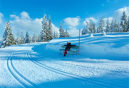 simsearch:400-07101023,k - Winter mountain fir forest snowy landscape (top of Papageno bahn - Filzmoos, Austria) and woman on bench. Photographie de stock - Aubaine LD & Abonnement, Code: 400-07244469