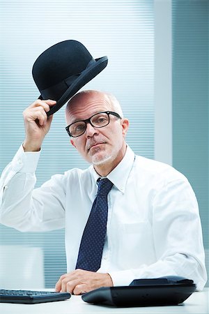 snob business man - Elegant english businessman with square glasses greeting  with his bowler Stock Photo - Budget Royalty-Free & Subscription, Code: 400-07244642