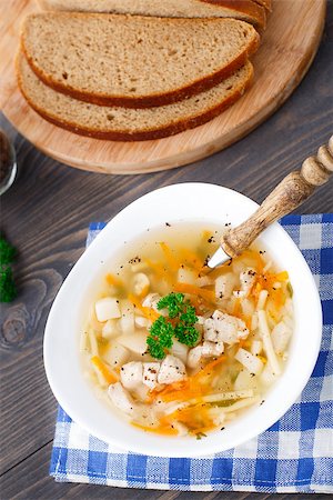 simsearch:400-04514565,k - Bowl of chicken soup with vegetables and noodles on a blue napkin Foto de stock - Super Valor sin royalties y Suscripción, Código: 400-07244668