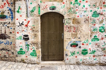 In the Old City of Jerusalem, many doorways of Arab families show where they have made religiious pilgrimages to Islamic sites through paintings on the walls near the door. Stock Photo - Budget Royalty-Free & Subscription, Code: 400-07244700