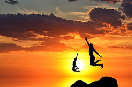 simsearch:400-07249987,k - people jumping from the top of the mountain on the background of the sunset Stock Photo - Budget Royalty-Free & Subscription, Code: 400-07245236