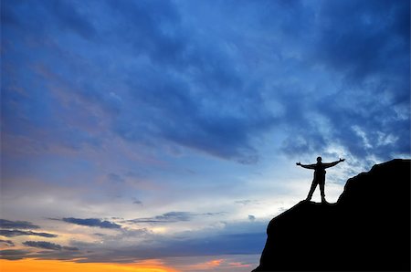 simsearch:400-08035788,k - man on top of the mountain reaches for the sun Fotografie stock - Microstock e Abbonamento, Codice: 400-07245256