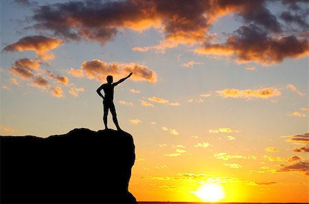 simsearch:400-08035788,k - man on top of the mountain reaches for the sun Fotografie stock - Microstock e Abbonamento, Codice: 400-07245250