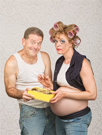 simsearch:400-07252384,k - Guilty pregnant woman eating candy with smiling man Photographie de stock - Aubaine LD & Abonnement, Code: 400-07245507