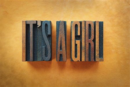 simsearch:400-07325569,k - The words IT'S A GIRL written in vintage letterpress type. Fotografie stock - Microstock e Abbonamento, Codice: 400-07245619