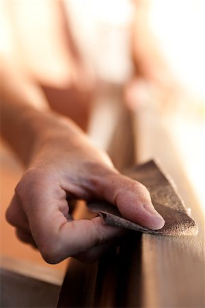 Hands of a woman with sandpaper doing DIY work on wooden fixtures Fotografie stock - Microstock e Abbonamento, Codice: 400-07246573