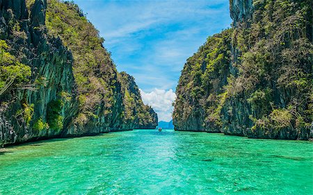 Tropical landscape - cristal clear water, rock islands, lonely boat Stock Photo - Budget Royalty-Free & Subscription, Code: 400-07246725