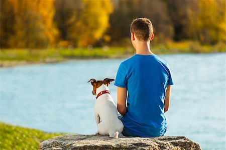 people animal cuddle - boy and his dog sitting together enjoying the view Stock Photo - Budget Royalty-Free & Subscription, Code: 400-07247023