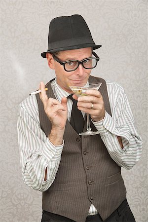 Smirking businessman with hat and eyeglasses drinking alcohol Stock Photo - Budget Royalty-Free & Subscription, Code: 400-07247184