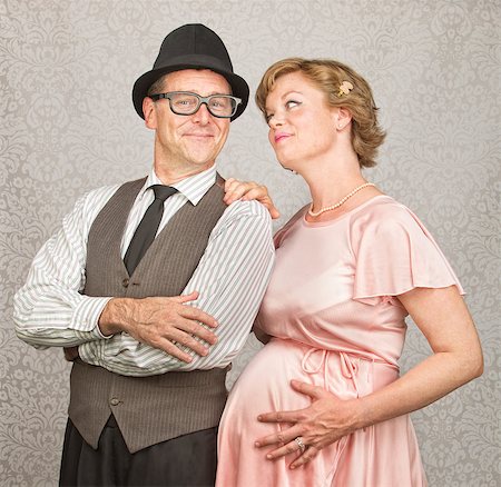 eyeglasses in the 1940s - Man with folded arms and happy pregnant female Stock Photo - Budget Royalty-Free & Subscription, Code: 400-07247207
