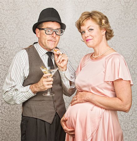 eyeglasses in the 1940s - Embarrassed smoker next to smiling pregnant female Stock Photo - Budget Royalty-Free & Subscription, Code: 400-07247201