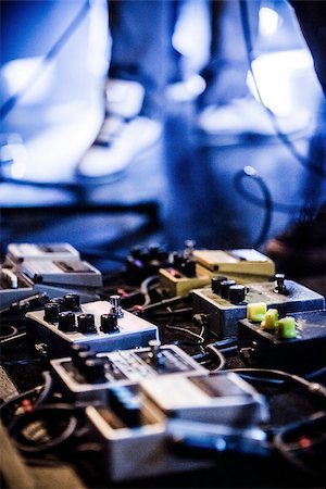 Guitar Pedals on a Stage with Live Band Performing During a Show. Low light image with copyspace Photographie de stock - Aubaine LD & Abonnement, Code: 400-07247241