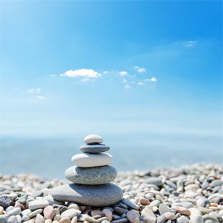 stack of zen stones over sea and clouds background Stockbilder - Microstock & Abonnement, Bildnummer: 400-07248142