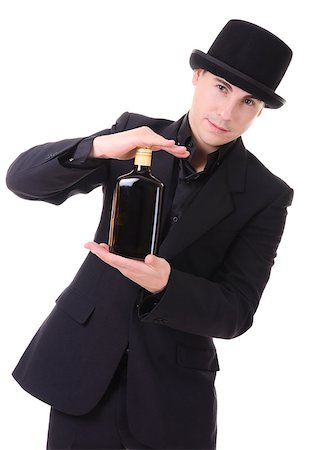 Handsome fashionable man in retro style with bottle of alcohol drink in his hand isolated on white background Stock Photo - Budget Royalty-Free & Subscription, Code: 400-07248361