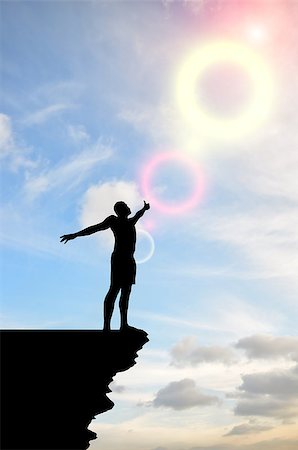 simsearch:400-08035788,k - man on top of the mountain reaches for the sun Fotografie stock - Microstock e Abbonamento, Codice: 400-07248684