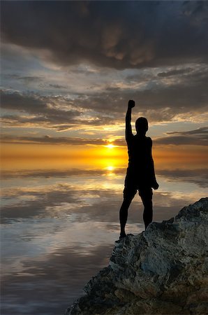 simsearch:400-08035788,k - man on top of the mountain reaches for the sun Fotografie stock - Microstock e Abbonamento, Codice: 400-07248690