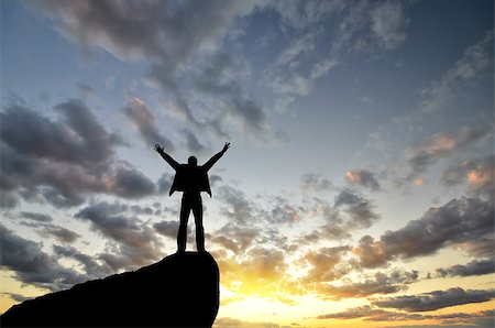 simsearch:400-08035788,k - man on top of the mountain reaches for the sun Fotografie stock - Microstock e Abbonamento, Codice: 400-07248708