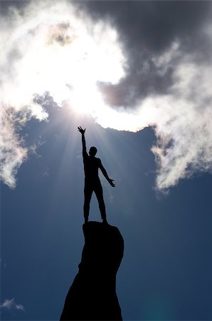 simsearch:400-08035788,k - man on top of the mountain reaches for the sun Fotografie stock - Microstock e Abbonamento, Codice: 400-07248747