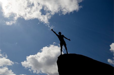 simsearch:400-08035788,k - man on top of the mountain reaches for the sun Fotografie stock - Microstock e Abbonamento, Codice: 400-07248748