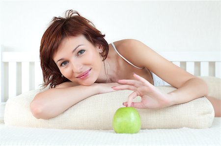 rozbyshaka (artist) - Portrait of an attractive young woman with an green apple at bed Stock Photo - Budget Royalty-Free & Subscription, Code: 400-07248896