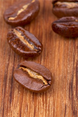 simsearch:400-04094520,k - Roasted Coffee Beans closeup on Wooden background Fotografie stock - Microstock e Abbonamento, Codice: 400-07249577