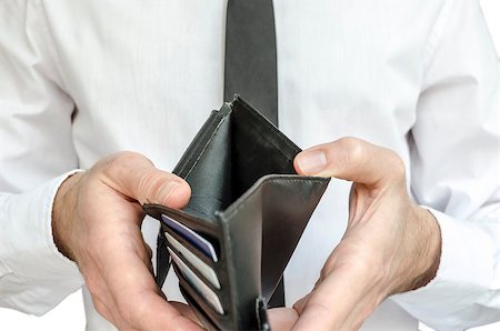 simsearch:400-07305634,k - Man in white shirt and black tie holding an empty wallet. Photographie de stock - Aubaine LD & Abonnement, Code: 400-07249747