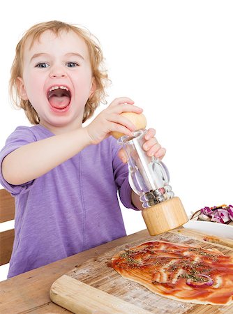 child with pepper making fresh pizza. studio shot isolated on white background Photographie de stock - Aubaine LD & Abonnement, Code: 400-07249848