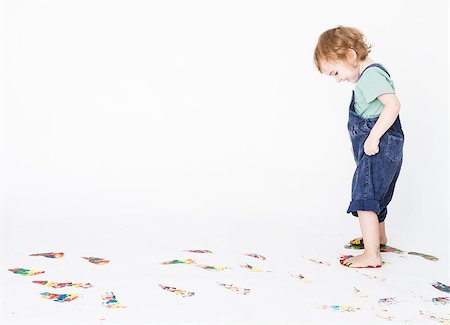 girl making colored footprints on the floor. studio shot with light grey background Stock Photo - Budget Royalty-Free & Subscription, Code: 400-07249849