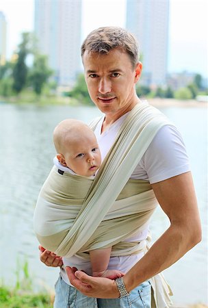 Father carrying his son in sling outdoors Stock Photo - Budget Royalty-Free & Subscription, Code: 400-07243854