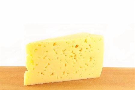 simsearch:400-07260354,k - piece of cheese on a wooden board on a white background Stockbilder - Microstock & Abonnement, Bildnummer: 400-07243978