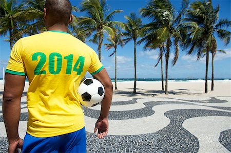 Brazilian soccer player holding football wears 2014 shirt in Brazil colors Rio de Janeiro Stock Photo - Budget Royalty-Free & Subscription, Code: 400-07254091