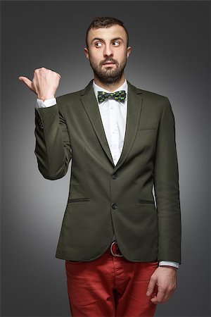 share work space - young man in a green suit, shows left Stock Photo - Budget Royalty-Free & Subscription, Code: 400-07254598