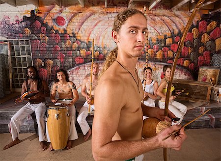 Handsome male capoeira musician with berimbau and group Foto de stock - Super Valor sin royalties y Suscripción, Código: 400-07256248