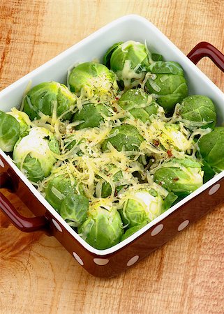 simsearch:400-07625359,k - Brussels Sprouts Casserole in Brown Polka Dot Bowl with Grated Cheese and Spices closeup on Wooden background Photographie de stock - Aubaine LD & Abonnement, Code: 400-07256439