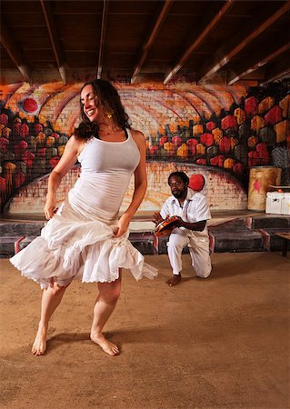 Happy Brazillian dancer and pandeiro performing indoors Stock Photo - Budget Royalty-Free & Subscription, Code: 400-07256617