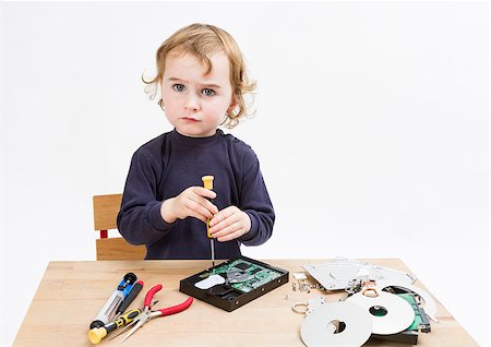 child repairing computer part. studio shot in light grey background Stock Photo - Budget Royalty-Free & Subscription, Code: 400-07256719