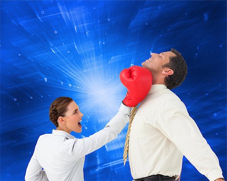 simsearch:400-07189733,k - Composite image of businesswoman hitting a businessman with boxing gloves on white background Stock Photo - Budget Royalty-Free & Subscription, Code: 400-07258128