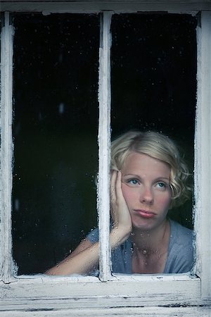 sad rainy day - Bored Woman Looking at the Rainy Weather By the Window Frame Stock Photo - Budget Royalty-Free & Subscription, Code: 400-07250117