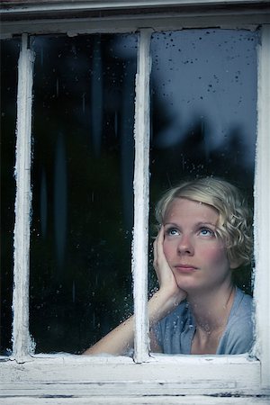 Bored Woman Looking at the Rainy Weather By the Window Frame Stock Photo - Budget Royalty-Free & Subscription, Code: 400-07250118