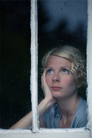 Bored Woman Looking at the Rainy Weather By the Window Frame Stock Photo - Budget Royalty-Free & Subscription, Code: 400-07250119