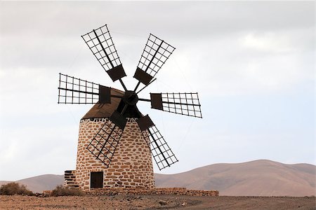 Puesta del sol de Tefia windmill in Fuerteventura Island (Spain) Fotografie stock - Microstock e Abbonamento, Codice: 400-07250127