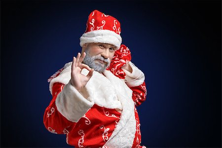 simsearch:400-05711921,k - Santa Claus shows OK sign on a dark background with blue color Stock Photo - Budget Royalty-Free & Subscription, Code: 400-07250323