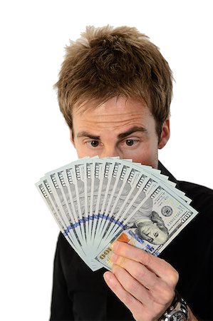 simsearch:700-02265003,k - A young handsome man holding a lot of new hundred dollar bills isolated on white background.  He is staring at the money.  This newly redesigned US currency was released for circulation in October of 2013. Stock Photo - Budget Royalty-Free & Subscription, Code: 400-07250657