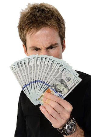 simsearch:700-02265003,k - A young handsome man holding a lot of new hundred dollar bills isolated on white background.  He is staring at the money with a look of disbelief.  This newly redesigned US currency was released for circulation in October of 2013. Stock Photo - Budget Royalty-Free & Subscription, Code: 400-07250658