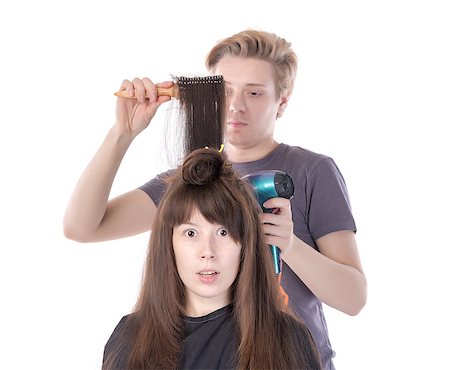 Woman enjoying having her hair blow dried, isolated on white Stock Photo - Budget Royalty-Free & Subscription, Code: 400-07250893