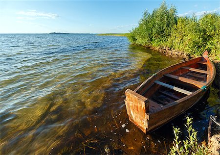 Summer evening lake view with wooden boat near shore Stock Photo - Budget Royalty-Free & Subscription, Code: 400-07251102