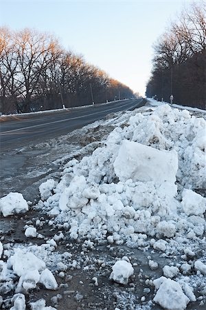 snowy road tree line - Big snow hummock on the roadside during sunset in winter evening Stock Photo - Budget Royalty-Free & Subscription, Code: 400-07251204