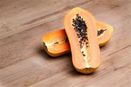 ripe fresh papaya half cut on wooden plate Stock Photo - Budget Royalty-Free & Subscription, Code: 400-07251248